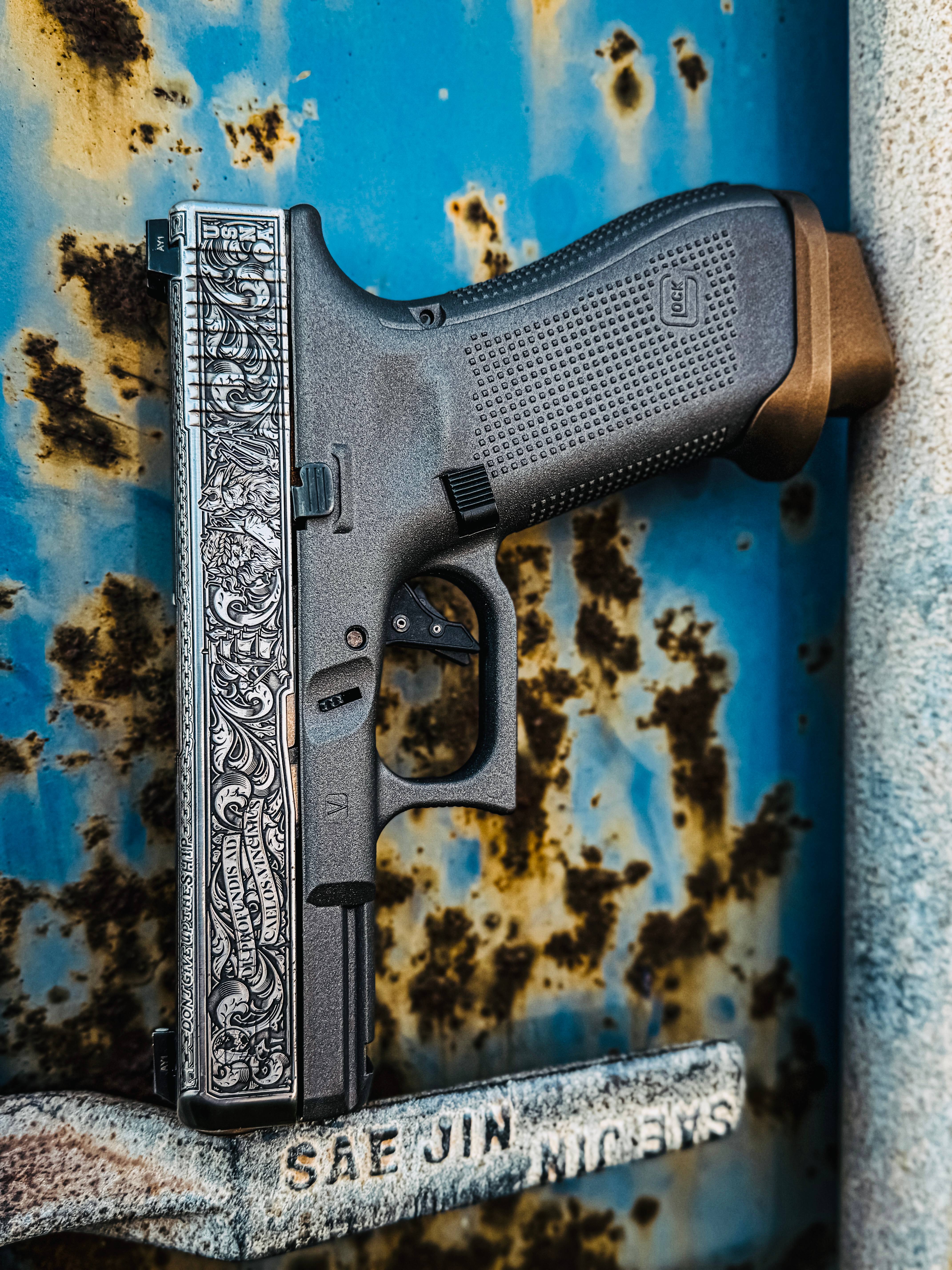 USNA Class of 2027 GLOCK 19X V — engraved slide against rusted metal background