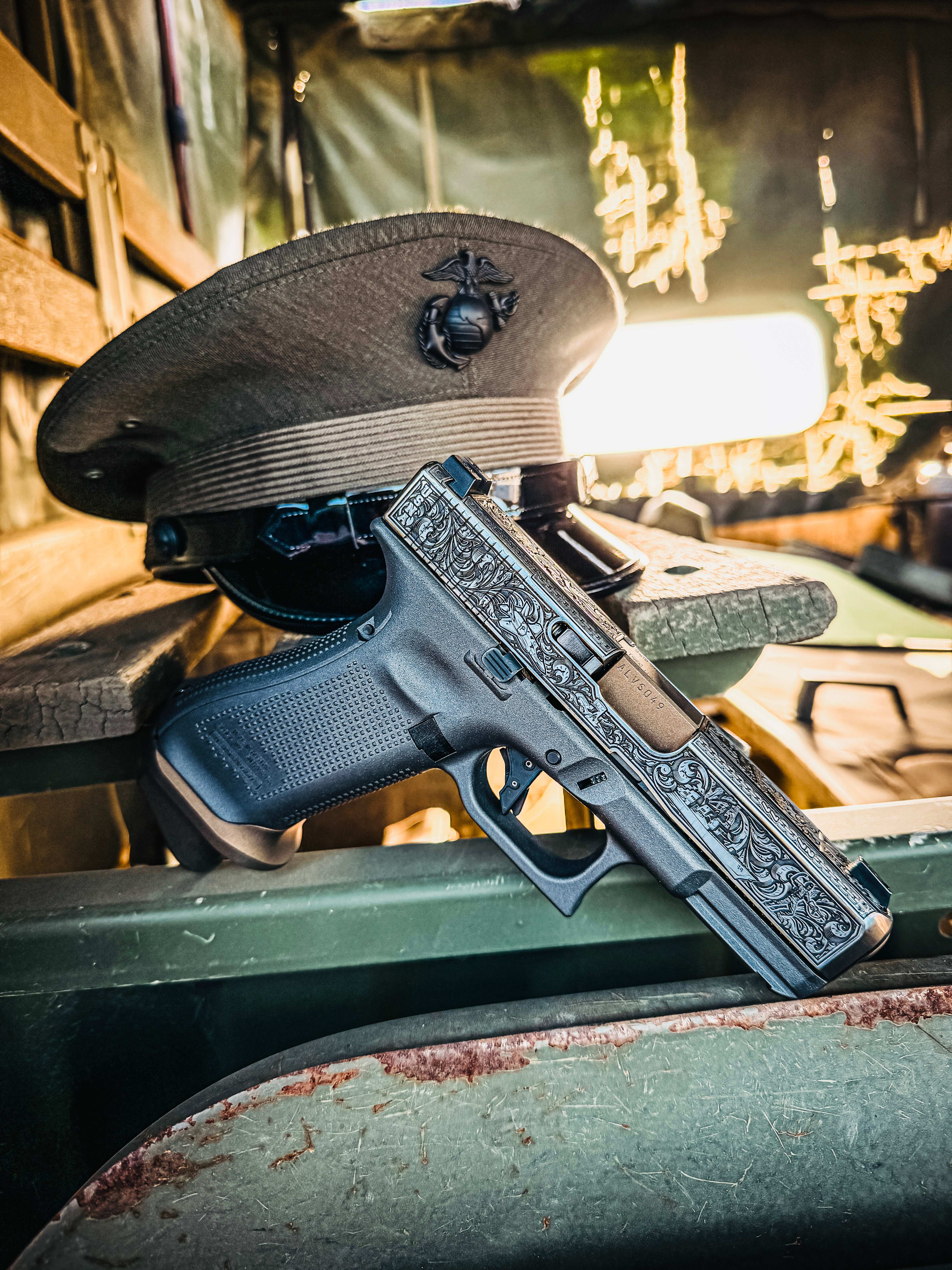 USNA Class of 2027 GLOCK 19X V — resting on Marine Corps officer's cover