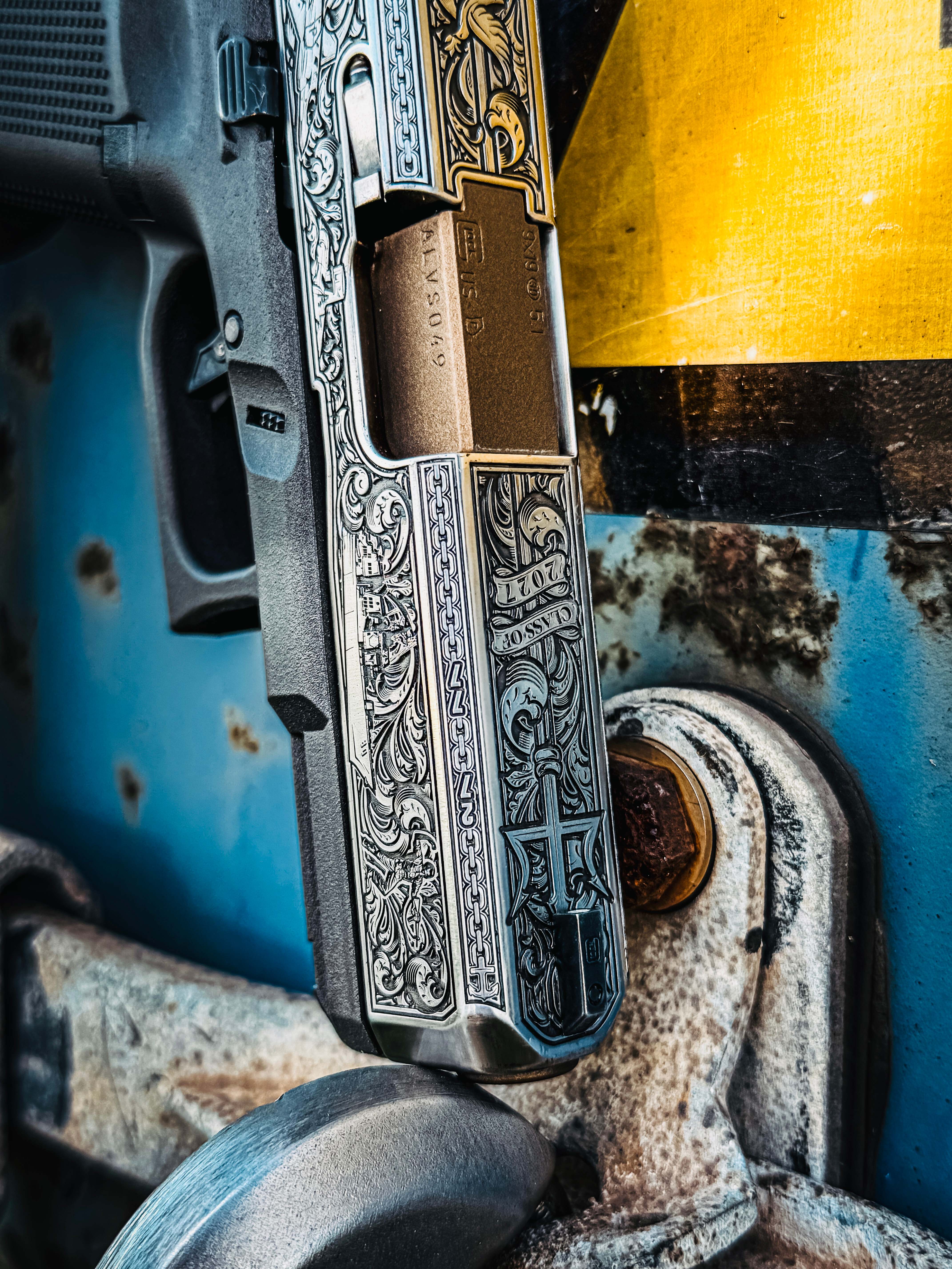 USNA Class of 2027 GLOCK 19X V — beside officer's cover, sunlit vehicle interior