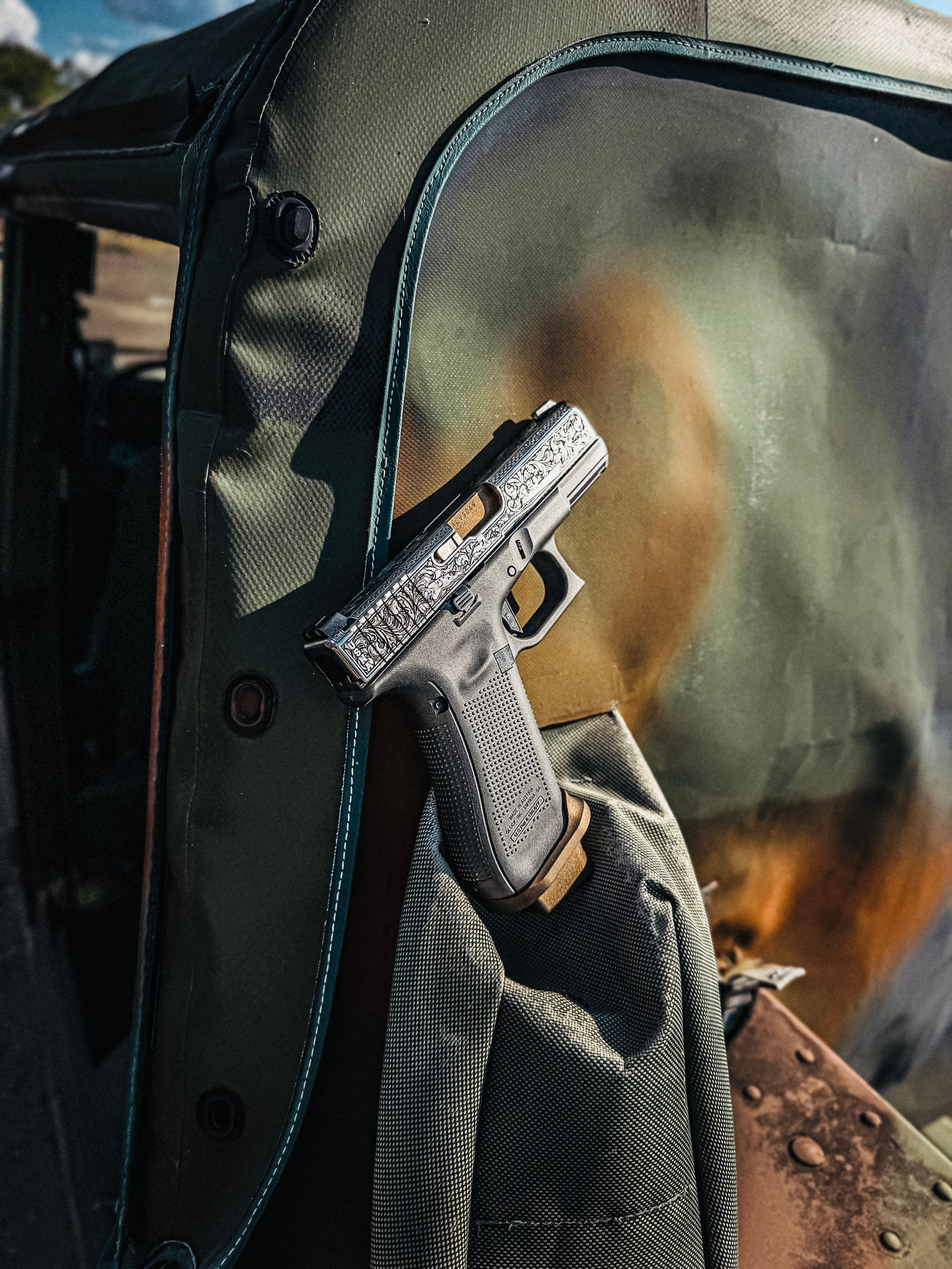 USNA Class of 2027 GLOCK 19X V — beside Marine Corps officer's cover, backlit vehicle interior