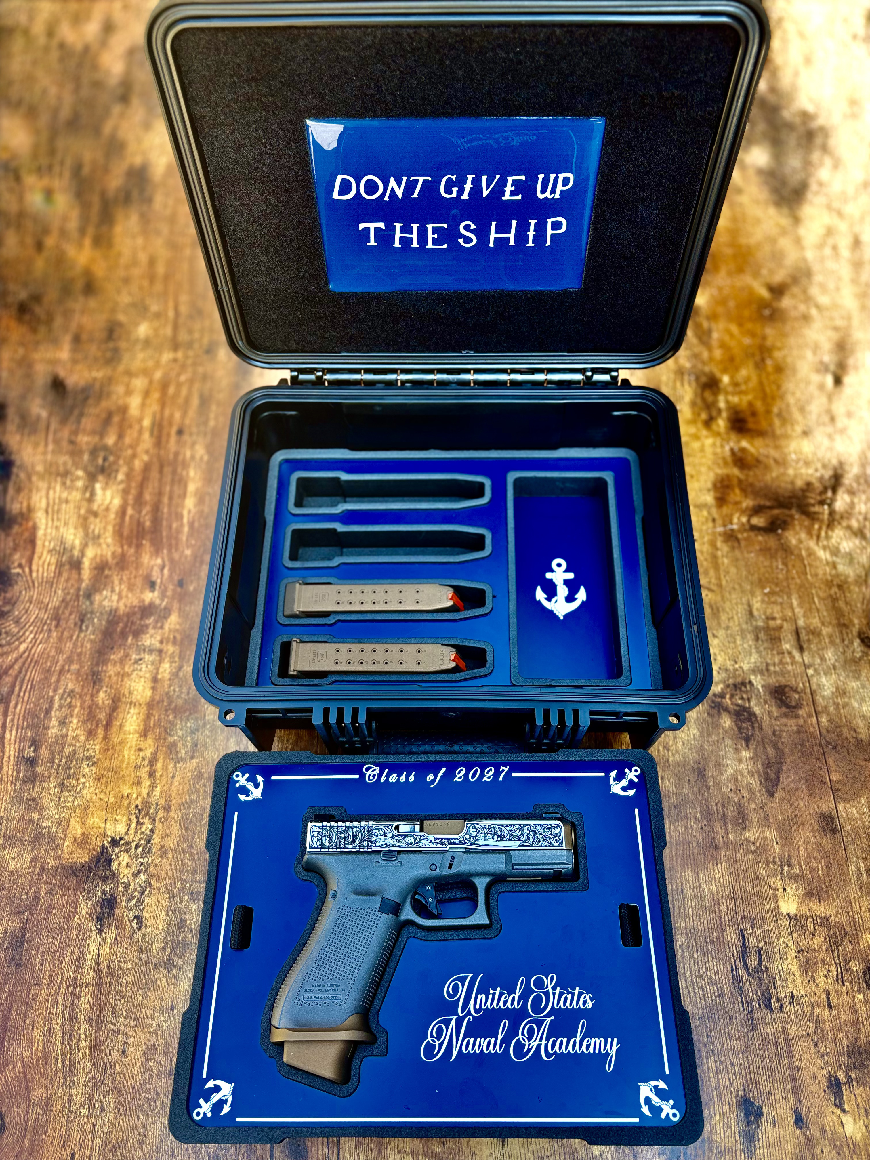 USNA Class of 2027 GLOCK 19X V — full presentation case layout with “Don't Give Up the Ship” lid panel, magazines, and “Class of 2027, United States Naval Academy” pistol tray