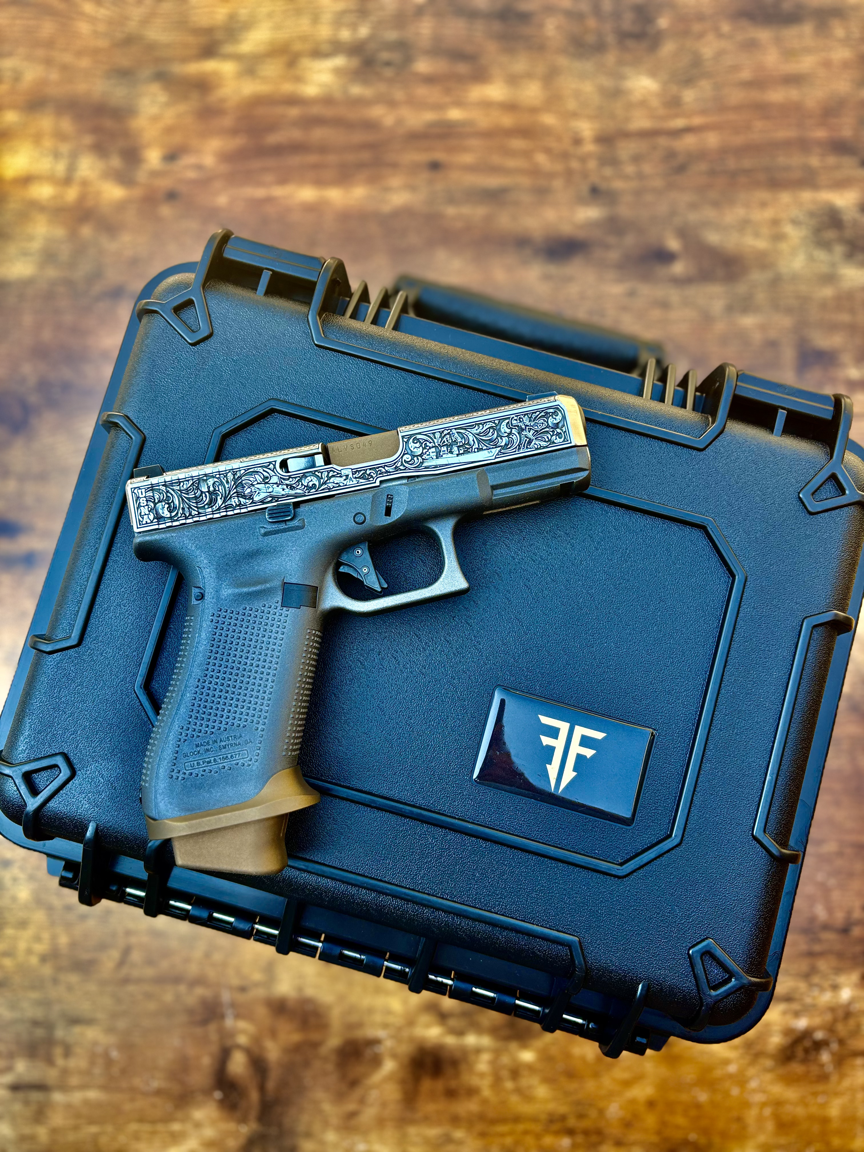USNA Class of 2027 GLOCK 19X V — engraved USNA slide resting on the closed black presentation case with the Firstie Firearms badge